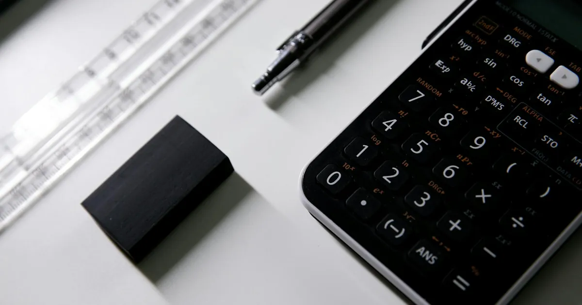 Close-up of a scientific calculator, ruler, and eraser on a desk, ideal for math or exam study visuals. Close-up of a scientific calculator, ruler, and eraser on a desk, ideal for math or exam study visuals.