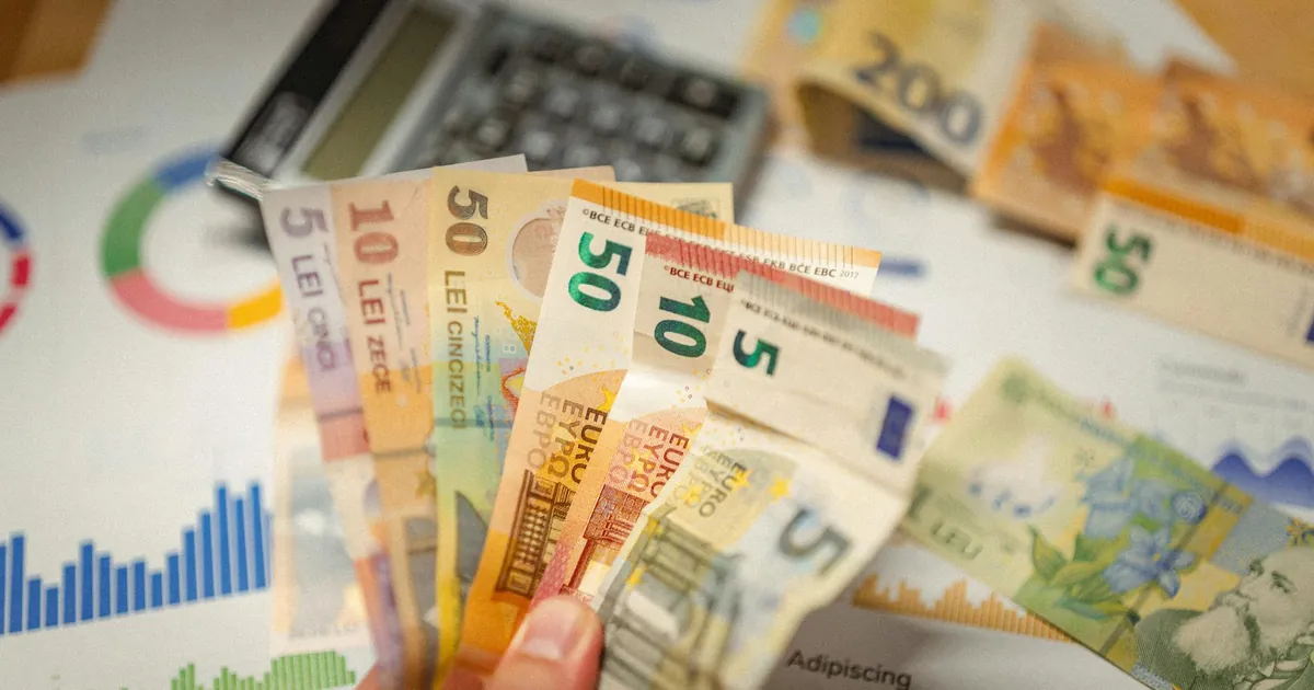 Close-up of currency notes with financial graphs and a calculator.