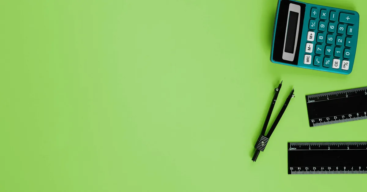 Calculator and drawing tools on a vibrant green background with ample copy space. Calculator and drawing tools on a vibrant green background with ample copy space.