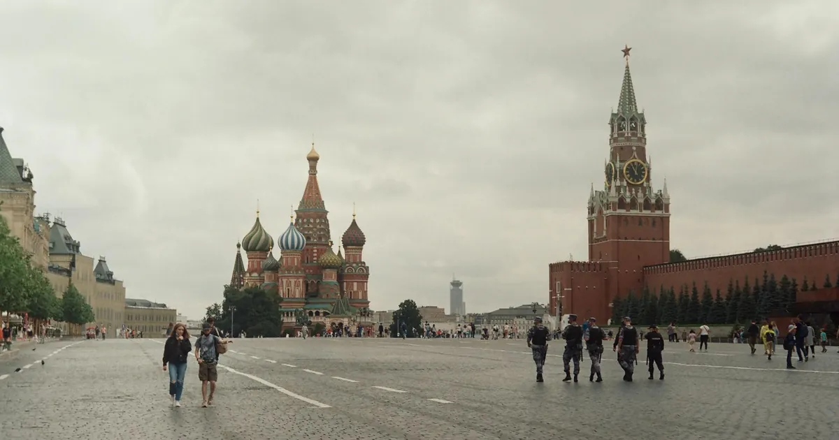 St. Basil's Cathedral and Kremlin in Moscow's Red Square on a cloudy day.