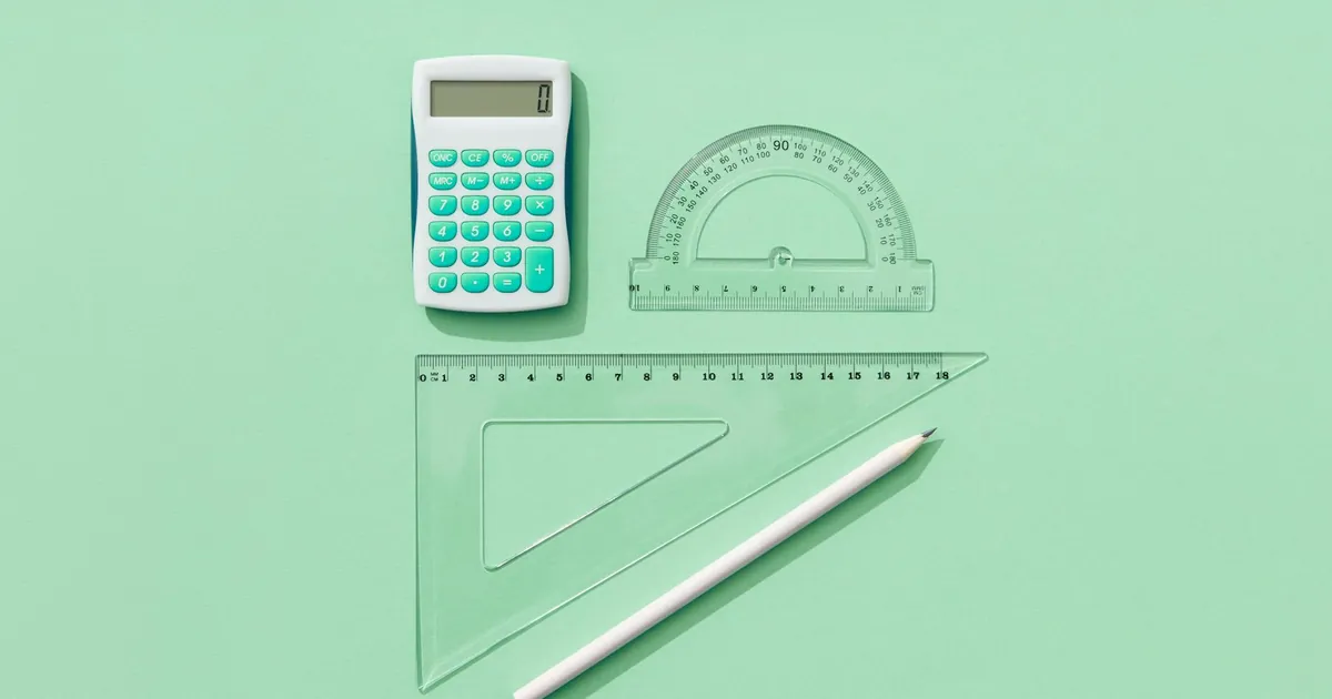 A minimalist flat lay of school supplies on a green background including a calculator, rulers, and pencil. A minimalist flat lay of school supplies on a green background including a calculator, rulers, and pencil.