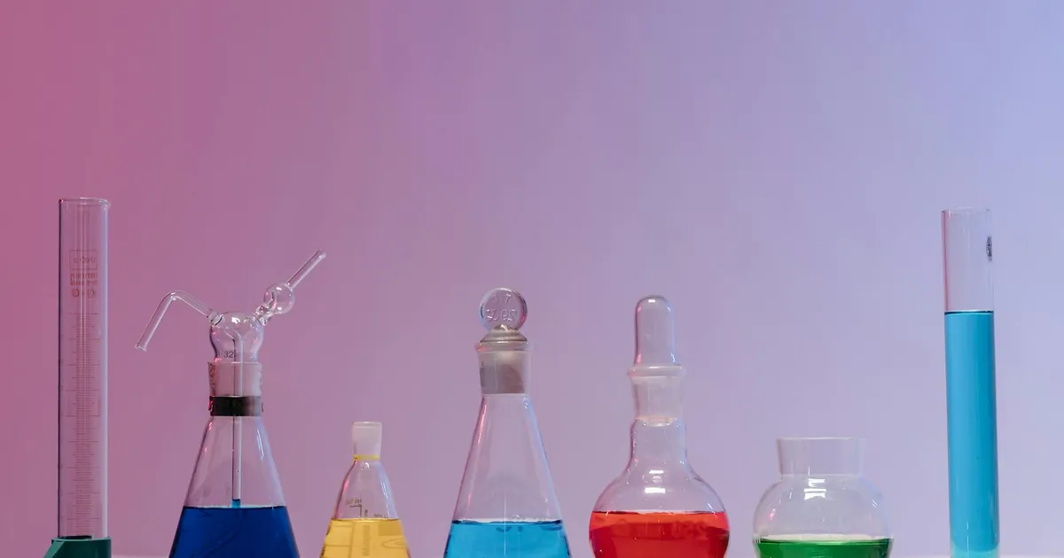 Vibrant glassware filled with colorful liquids in a laboratory setting. Vibrant glassware filled with colorful liquids in a laboratory setting.