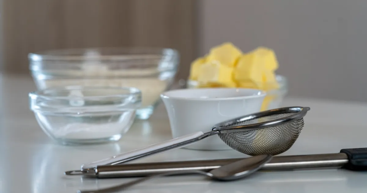 silver and black kitchen utensil on white ceramic bowl