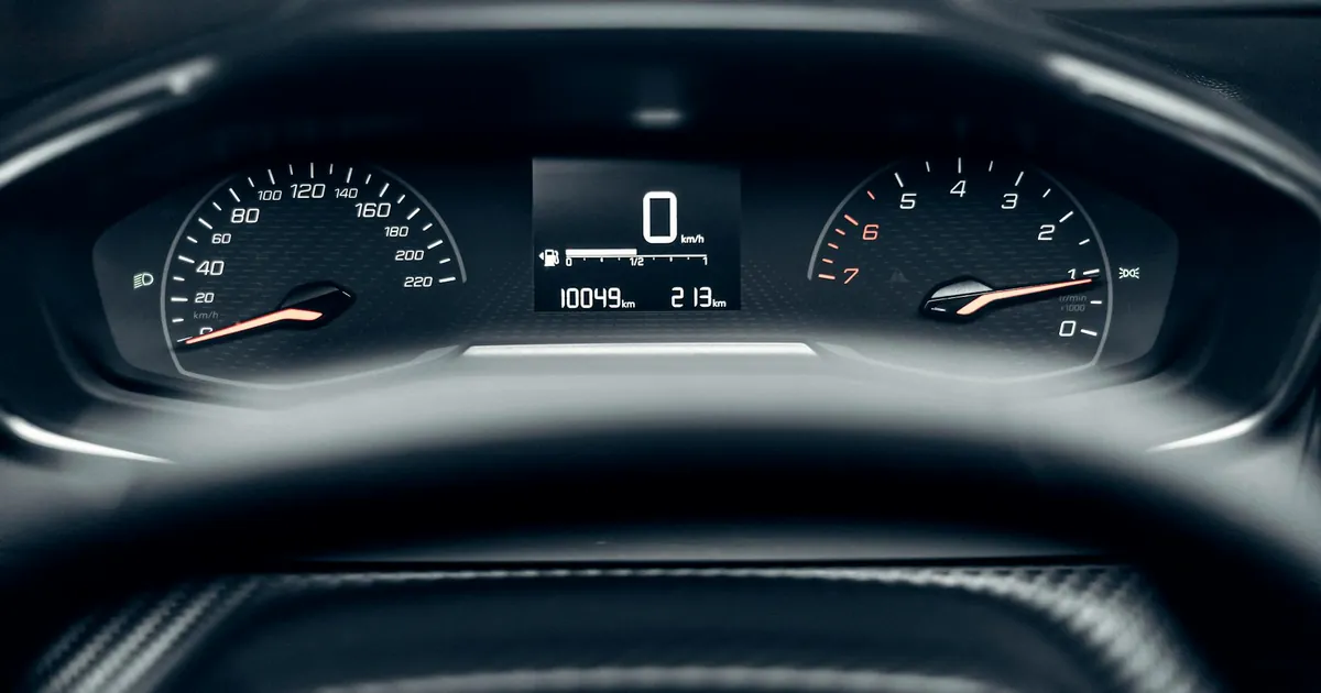 Detailed view of a modern car dashboard showing speedometer, odometer, and tachometer.