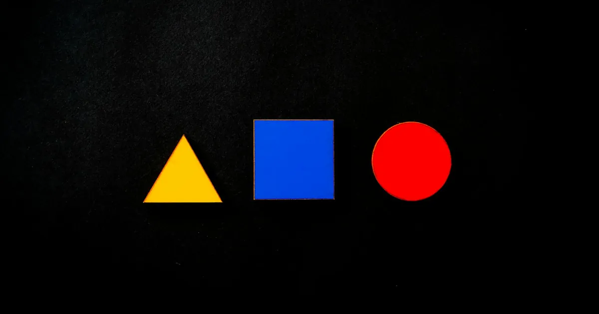 Vivid geometric shapes of triangle, square, and circle in primary colors on a black background. Vivid geometric shapes of triangle, square, and circle in primary colors on a black background.